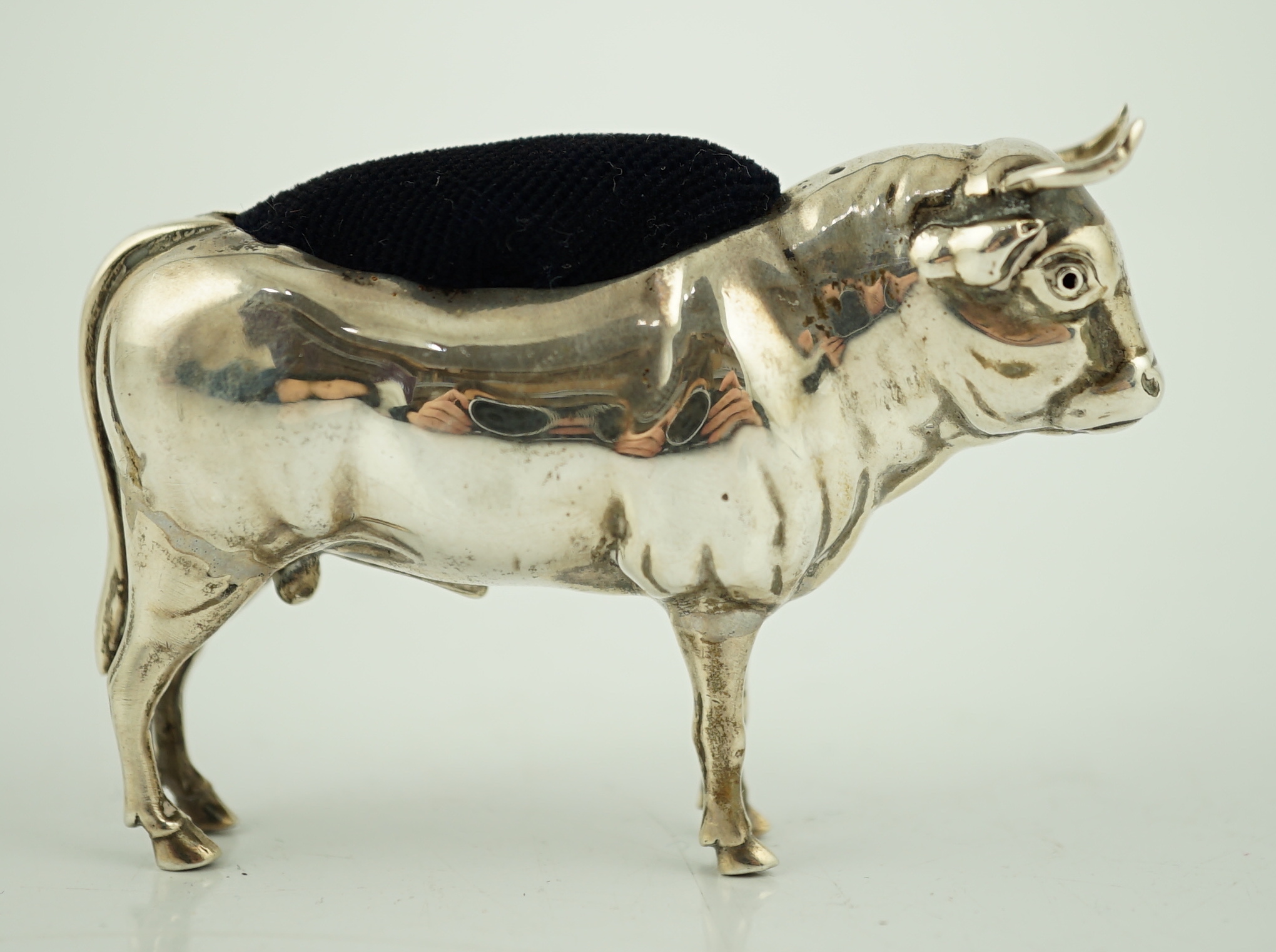 An Edwardian novelty silver pin cushion, modelled as a bull, Cohen & Charles